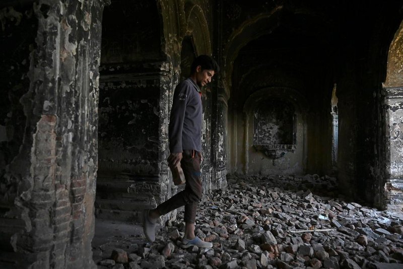 A labourer walks inside the centuries old Raghunath Hindu temple during restoration works by the Jammu and Kashmir Tourism department, in Srinagar on September 22, 2020. (Photo by TAUSEEF MUSTAFA / AFP)<!-- NICAID(14601420) -->