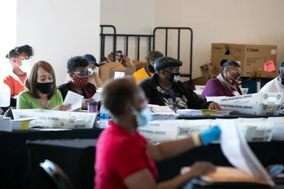 ATLANTA, GA - NOVEMBER 04: Election workers count Fulton County ballots at State Farm Arena on November 4, 2020 in Atlanta, Georgia. The 2020 presidential race between incumbent U.S. President Donald Trump and Democratic nominee Joe Biden is still too close to call with outstanding ballots to count.   Jessica McGowan/Getty Images/AFP
