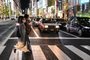 A couple cross a street in Tokyo on December 7, 2020. (Photo by CHARLY TRIBALLEAU / AFP)<!-- NICAID(14662842) -->