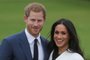 Britains Prince Harry and his fiancée US actress Meghan Markle pose for a photograph in the Sunken Garden at Kensington Palace in west London on November 27, 2017, following the announcement of their engagementBritains Prince Harry will marry his US actress girlfriend Meghan Markle early next year after the couple became engaged earlier this month, Clarence House announced on Monday. / AFP PHOTO / Daniel LEAL-OLIVAS