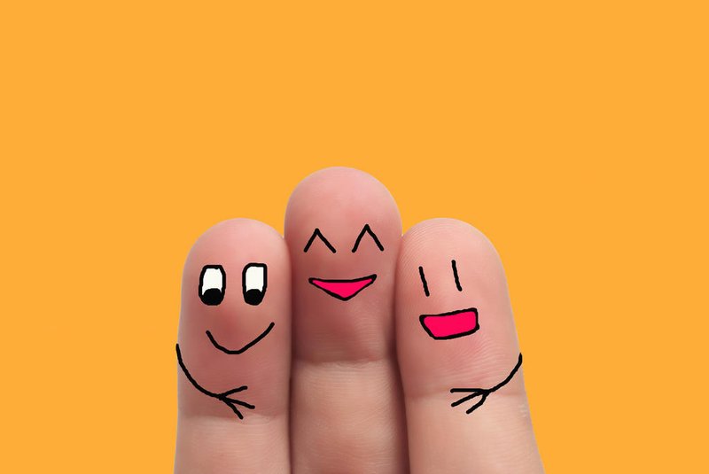 three best friends hands fingers of man and woman on yellow backgroundFonte: 311690047<!-- NICAID(14869651) -->