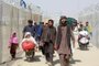 Afghan people walk inside a fenced corridor as they enter Pakistan at the Pakistan-Afghanistan border crossing point in Chaman on August 25, 2021 following the Talibans stunning military takeover of Afghanistan. (Photo by - / AFP)<!-- NICAID(14871416) -->