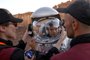 Technicians assist an astronaut from a team from Europe and Israel to suit up in a spacesuit before starting a training mission for planet Mars at a site that simulates an off-site station at the Ramon Crater in Mitzpe Ramon in Israels southern Negev desert on October 10, 2021. - Six astronauts from Portugal, Spain, Germany, the Netherlands, Austria, and Israel will be cut off from the world for a month, from October 4-31, only able leave their habitat in spacesuits as if they were on Mars. Their mission, the AMADEE-20 Mars simulation, will be carried out in a Martian terrestrial analog and directed by a dedicated Mission Support Center in Austria, to conduct experiments ahead of future human and robotic Mars exploration missions. (Photo by JACK GUEZ / AFP)<!-- NICAID(14912392) -->