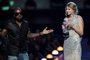 NEW YORK - SEPTEMBER 13:  Kanye West takes the microphone from Taylor Swift and speaks onstage during the 2009 MTV Video Music Awards at Radio City Music Hall on September 13, 2009 in New York City.  (Photo by Kevin Mazur/WireImage) <!-- NICAID(14255261) -->