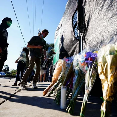 HOUSTON, TX - NOVEMBER 06: A festival patron is seen leading flowers outside of the canceled Astroworld festival at NRG Park on November 6, 2021 in Houston, Texas. According to authorities, eight people died and 17 people were transported to local hospitals after what they describe as a crowd surge at the Astroworld festival, a music festival started by Houston-native rapper and musician Travis Scott in 2018.   Alex Bierens de Haan/Getty Images/AFP (Photo by Alex Bierens de Haan / GETTY IMAGES NORTH AMERICA / Getty Images via AFP)<!-- NICAID(14934787) -->