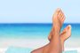Vacation holidays relaxing conceptVacation holidays. Woman feet closeup of girl relaxing on beach on sunbed enjoying sun on sunny summer day.Indexador: MaridavFonte: 49127599<!-- NICAID(14975961) -->
