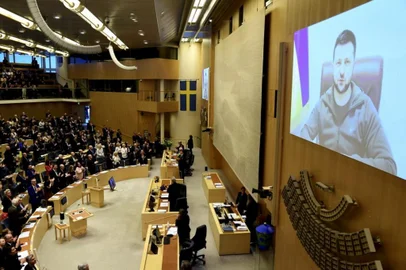 Ukrainian president Volodymyr Zelensky (R) is displayed on a screen as he adresses Swedens parliament in Stockholm on March 24, 2022. (Photo by Paul WENNERHOLM / TT News Agency / AFP) / Sweden OUT<!-- NICAID(15049617) -->