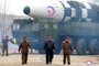 This picture taken on March 24, 2022 and released from North Koreas official Korean Central News Agency (KCNA) on March 25, 2022 shows North Korean leader Kim Jong Un (C) walking near what state media report says a new type inter-continental ballistic missile (ICBM), Hwasongpho-17 of North Koreas strategic forces before its test launch in an undisclosed location in North Korea. (Photo by various sources / AFP) / South Korea OUT / ---EDITORS NOTE--- RESTRICTED TO EDITORIAL USE - MANDATORY CREDIT AFP PHOTO/KCNA VIA KNS - NO MARKETING NO ADVERTISING CAMPAIGNS - DISTRIBUTED AS A SERVICE TO CLIENTS / THIS PICTURE WAS MADE AVAILABLE BY A THIRD PARTY. AFP CAN NOT INDEPENDENTLY VERIFY THE AUTHENTICITY, LOCATION, DATE AND CONTENT OF THIS IMAGE --- / <!-- NICAID(15050803) -->