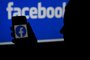 (FILES) In this file illustration photo taken on April 7, 2021, a smart phone screen displays the logo of Facebook on a Facebook website background, in Arlington, Virginia. - Facebook on June 21, 2021 began rolling out its service for people seeking audio-based connections in a direct challenge to the upstart social platform Clubhouse. The live audio rooms will enable users of the social media giant to listen to, and sometimes participate in, conversations led by celebrities and influencers or create a fundraiser on the platform. (Photo by OLIVIER DOULIERY / AFP)<!-- NICAID(14820643) -->