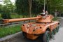 Truong Van Dao and his son ride in a wooden tank made from the conversion of an old minibus in a residential area in Bac Ninh province on March 28, 2022. - A Vietnamese father spent hundreds of hours, investing thousands, to convert an old van into a wooden tank for his son -- an unusual hobby in a country once ravaged by war. (Photo by Nhac NGUYEN / AFP)Editoria: LIFLocal: Bac NinhIndexador: NHAC NGUYENSecao: transportFonte: AFPFotógrafo: STF<!-- NICAID(15053954) -->