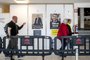 Voters walk past electoral posters of the two candidates as they arrive for the second round of Frances presidential election at a polling station in Brussels, on April 24, 2022. (Photo by HATIM KAGHAT / Belga / AFP) / Belgium OUT<!-- NICAID(15076461) -->