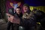 This handout picture taken and released by the Ukrainian Presidential press service on December 6, 2022, shows Ukrainian President Volodymyr Zelensky posing for a selfie picture with a Ukrainian soldier as he visits the Donetsk region, amid the Russian invasion of Ukraine. - President Volodymyr Zelensky on December 6, 2022 visited the frontline region of Donetsk in east Ukraine, describing fighting in the area as difficult with Russian forces pushing to capture the industrial city of Bakhmut. From the bottom of my heart, I congratulate you on this great holiday, the Day of the Armed Forces, said Zelensky, who was later shown meeting soldiers and distributing awards. (Photo by UKRAINIAN PRESIDENTIAL PRESS SERVICE / AFP) / RESTRICTED TO EDITORIAL USE - MANDATORY CREDIT AFP PHOTO / UKRAINIAN PRESIDENTIAL PRESS SERVICE  - NO MARKETING NO ADVERTISING CAMPAIGNS - DISTRIBUTED AS A SERVICE TO CLIENTS<!-- NICAID(15287163) -->