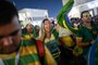 Brazils supporters celebrate and wave Brazilian flags at the Souq Waqif marketplace in Doha on November 30, 2022, during the Qatar 2022 World Cup football tournament. (Photo by OZAN KOSE / AFP)<!-- NICAID(15289986) -->