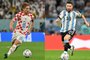 (COMBO) This combination picture made on December 11, 2022 during the Qatar 2022 World Cup football tournament shows Croatias midfielder Luka Modric (L) in Doha on December 9, 2022 and Argentinas forward Lionel Messi in Doha on December 3, 2022. - Argentina will play Croatia in the Qatar 2022 World Cup football semi-final match in Doha on December 13, 2022. (Photo by Nelson ALMEIDA and Alfredo ESTRELLA / AFP)<!-- NICAID(15293248) -->