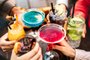 People hands toasting multicolored fancy drinks - Young friends having fun together drinking cocktails at happy hour - Social gathering party time concept on warm vivid filterFonte: 435395998<!-- NICAID(15306070) -->