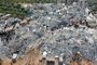 This aerial view shows residents searching for victims and survivors amidst the rubble of collapsed buildings following an earthquake in the village of Besnia near the twon of Harim, in Syrias rebel-held noryhwestern Idlib province on the border with Turkey, on February 6, 2022. - Hundreds have been reportedly killed in north Syria after a 7.8-magnitude earthquake that originated in Turkey and was felt across neighbouring countries. (Photo by Omar HAJ KADOUR / AFP)<!-- NICAID(15342190) -->